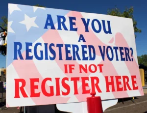 Sign that says: Are you a registered voter? If not register here
